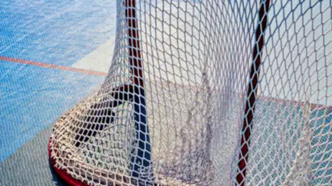 A hockey goal net on an outdoor court