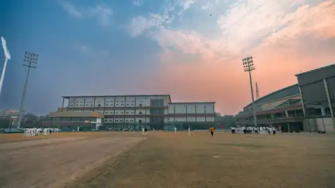 Stadium floodlights at sunset